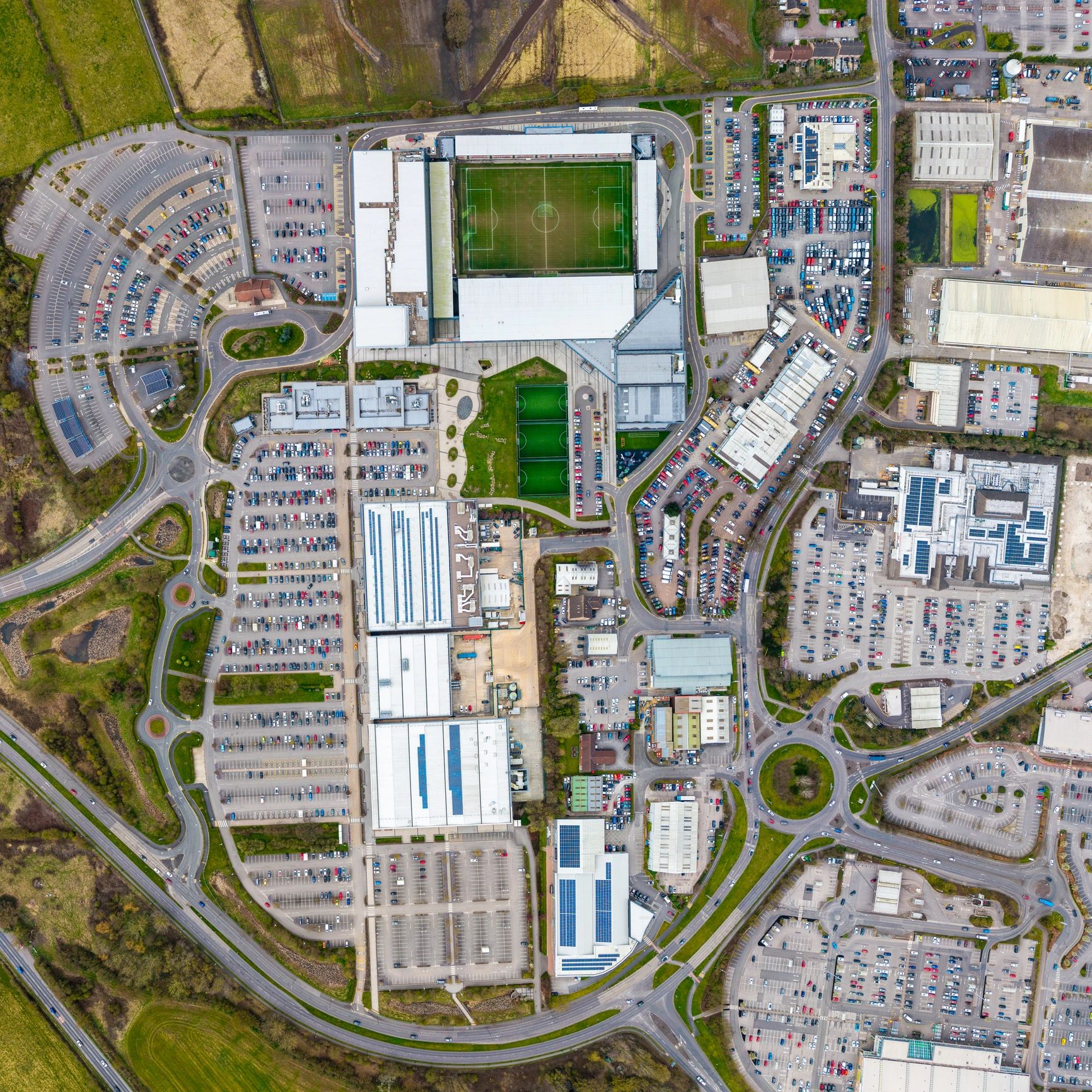 Aerial map-style view of a large commercial shopping centre with parking aisles, perimeter roads and site circulation suggesting documented winter patrol routes